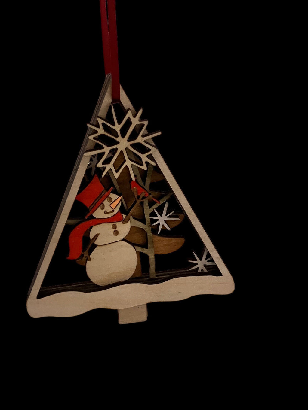 Laser-cut layered Christmas ornament with snowman and tree