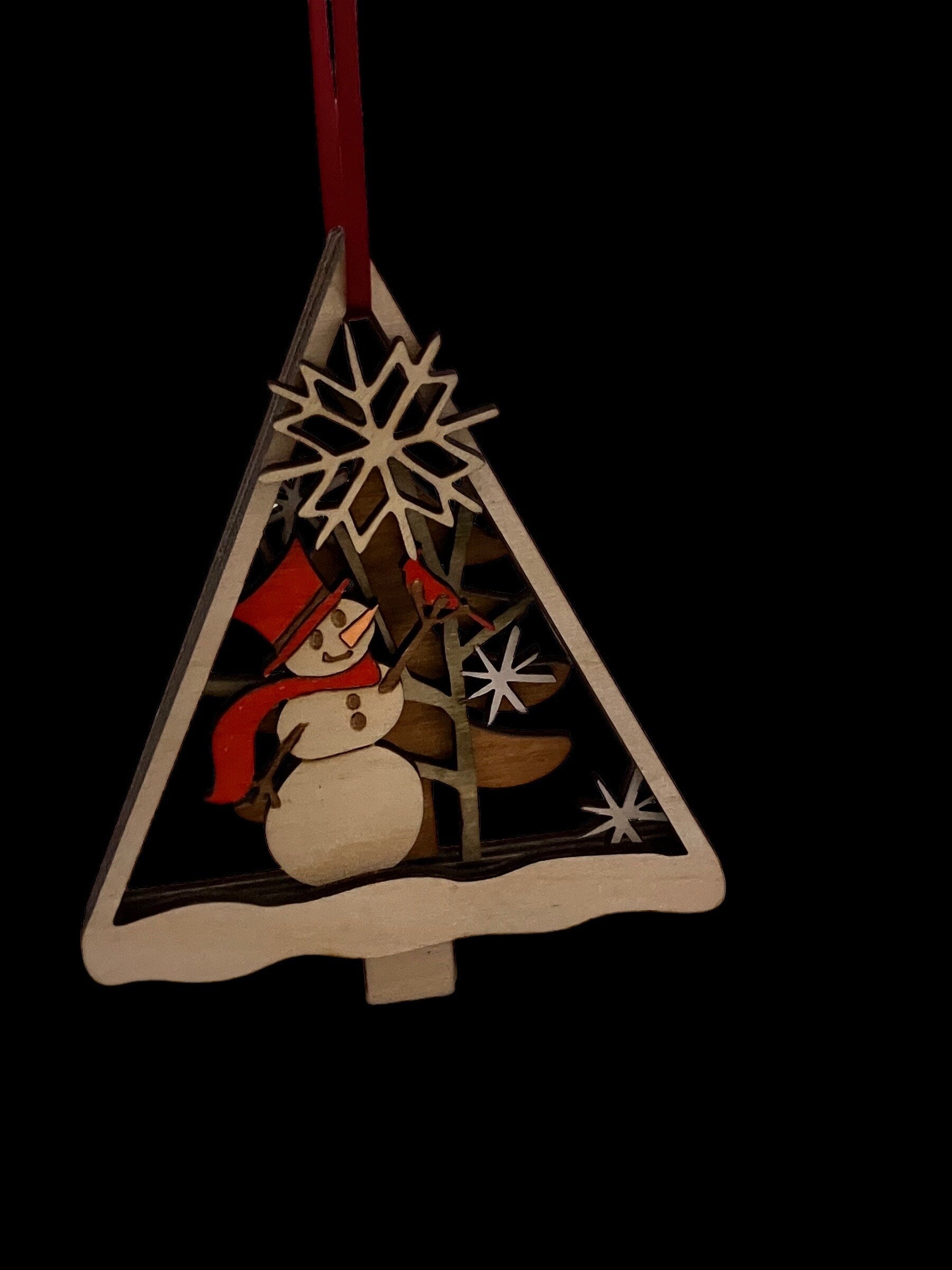 Laser-cut layered Christmas ornament with snowman and tree