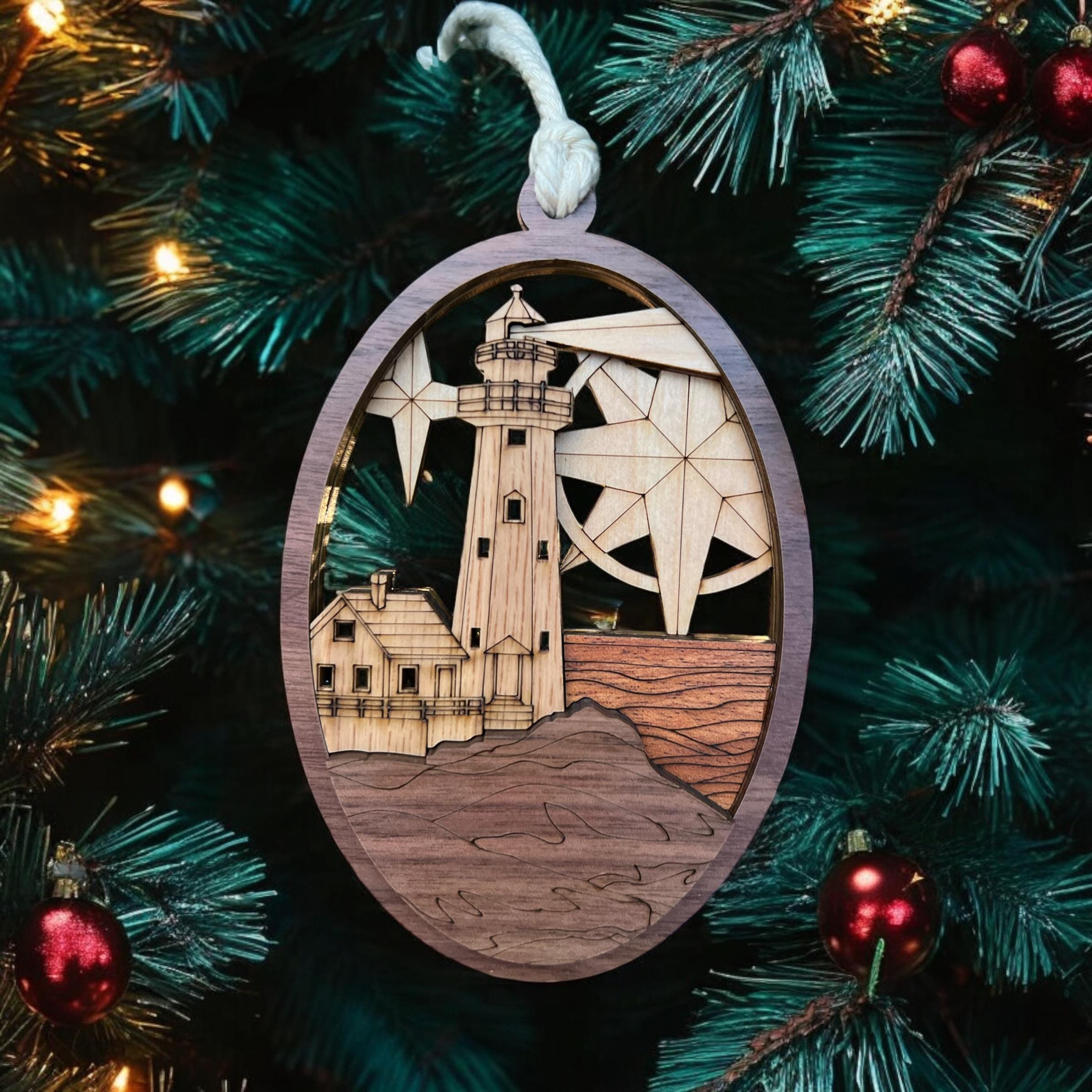 Decorative ornament with a lighthouse design on a Christmas tree.