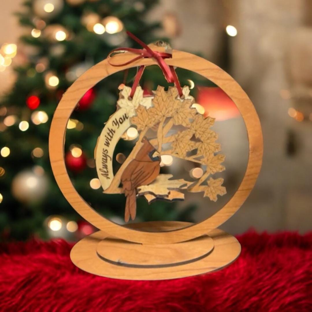 Sympathy gift ornament displayed beside Christmas greenery