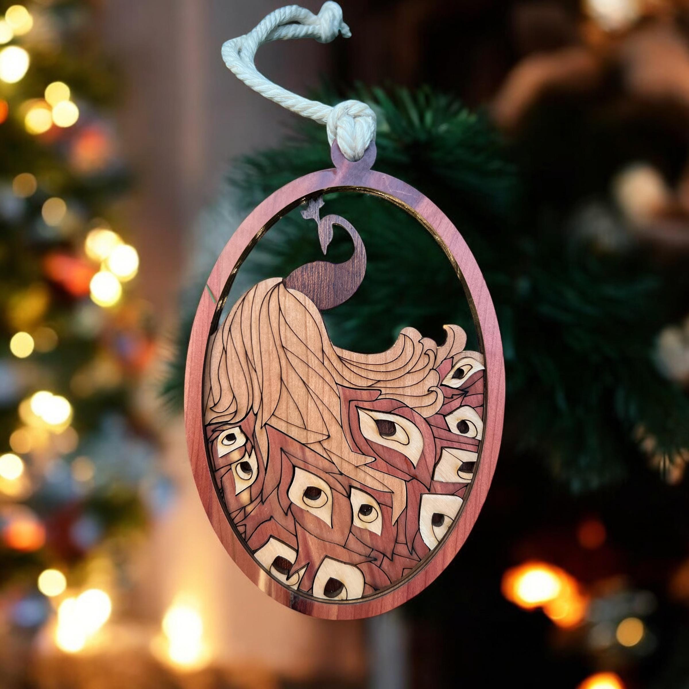 Decorative ornament with intricate design on a blurred Christmas tree background