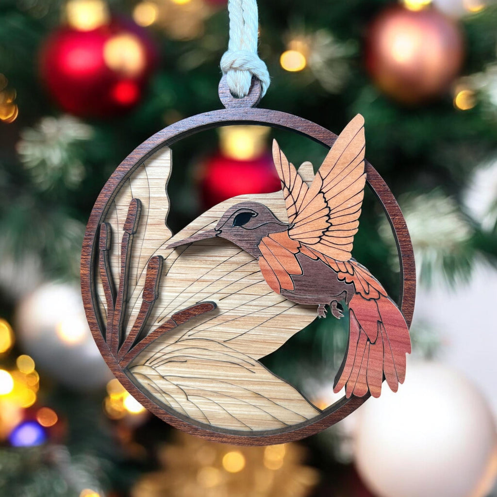 Laser-cut wooden hummingbird ornament hanging on Christmas tree