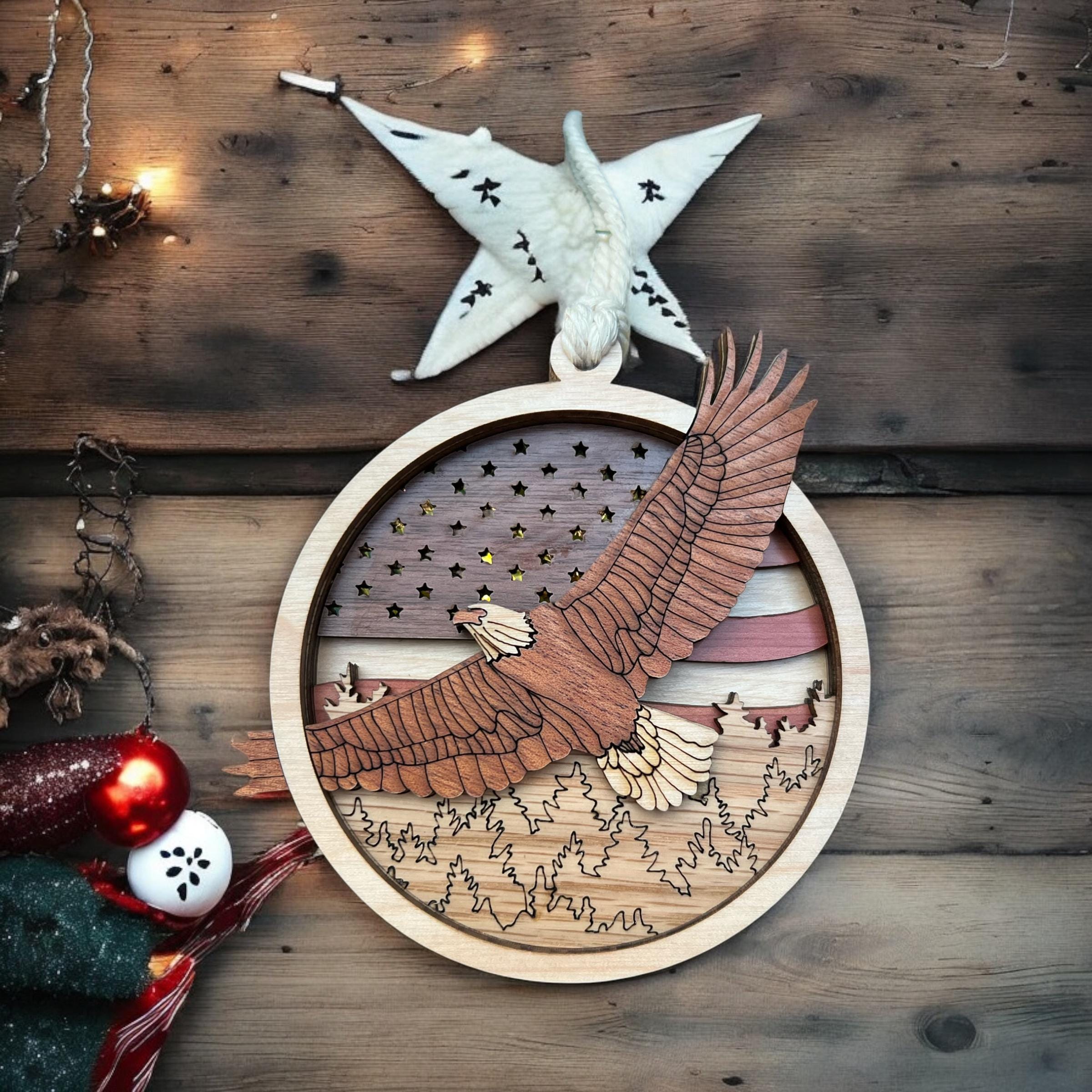 Wooden ornament with eagle design on a wooden surface with Christmas decorations.