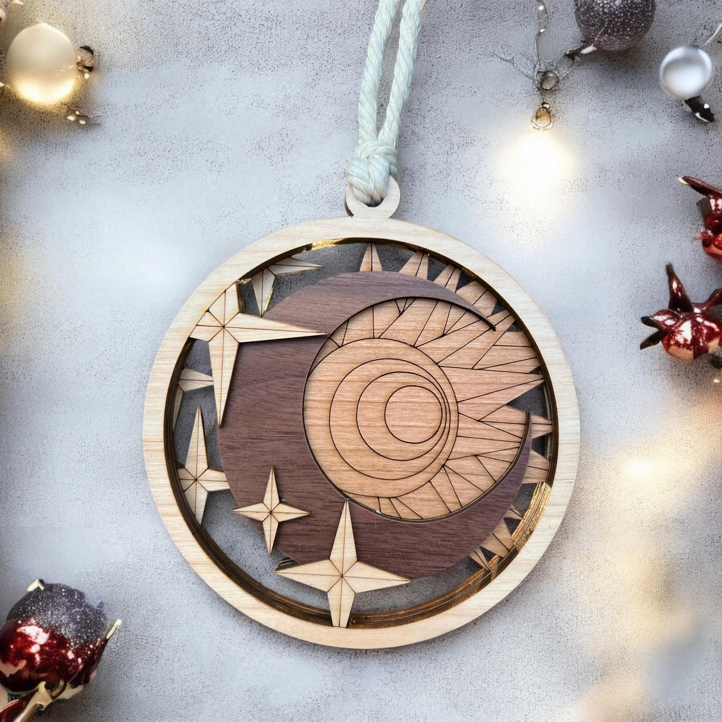 Layered wooden sun and moon ornament with laser-cut stars