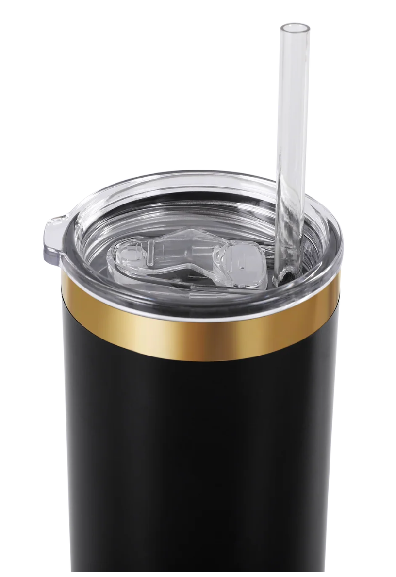Black tumbler with gold rim and clear straw on a white background