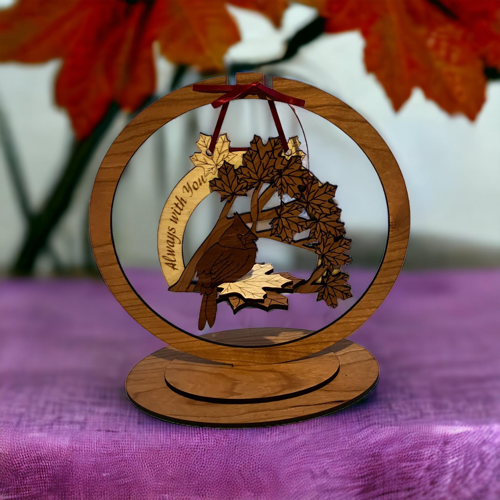 Laser-cut wooden memorial ornament with red ribbon and stand