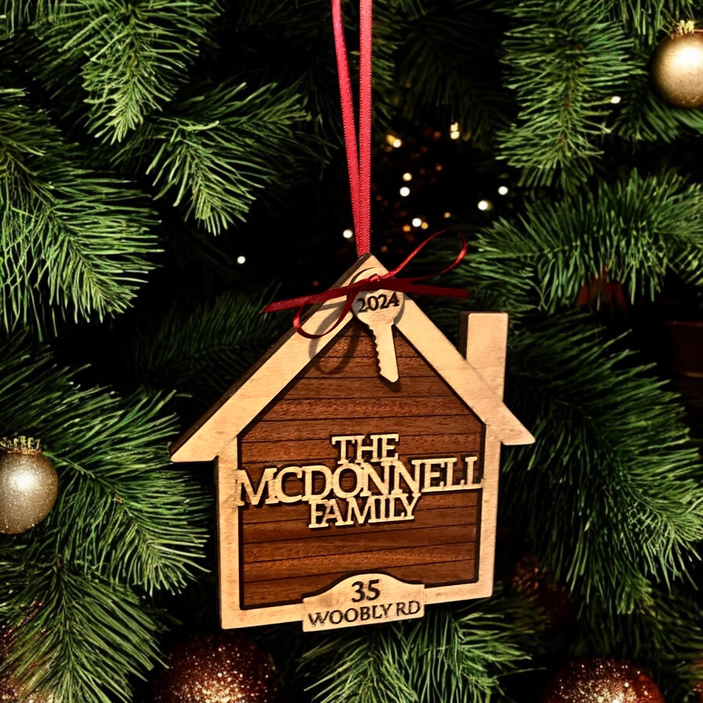 Custom engraved house ornament hanging on Christmas tree