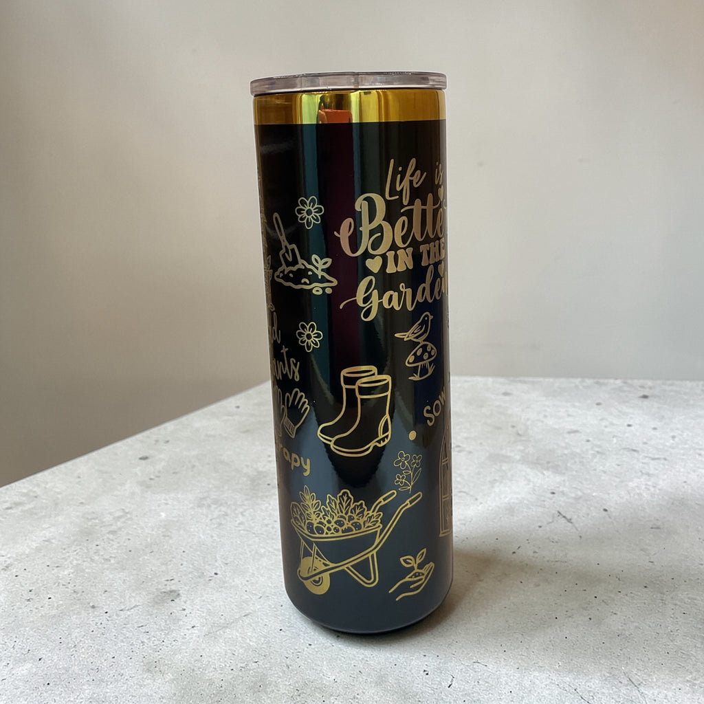Tumbler with garden-themed design and text on a light surface.