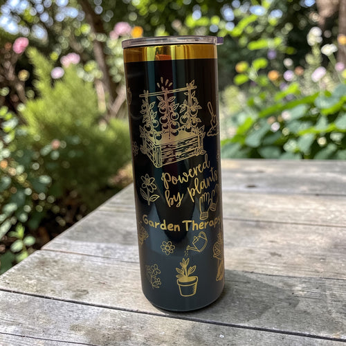 Tumbler with garden-themed design on a wooden surface outdoors