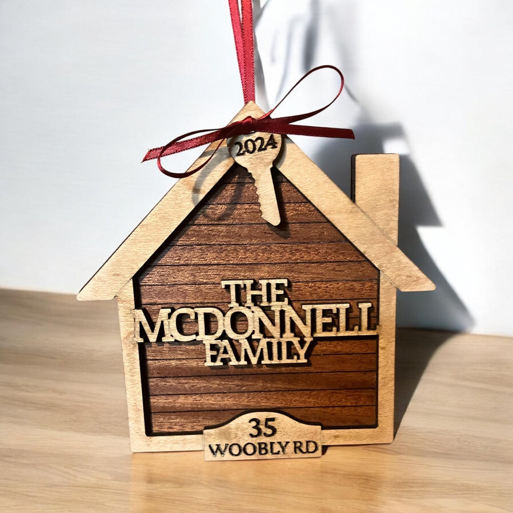 Laser-cut wood home ornament with key and year detail