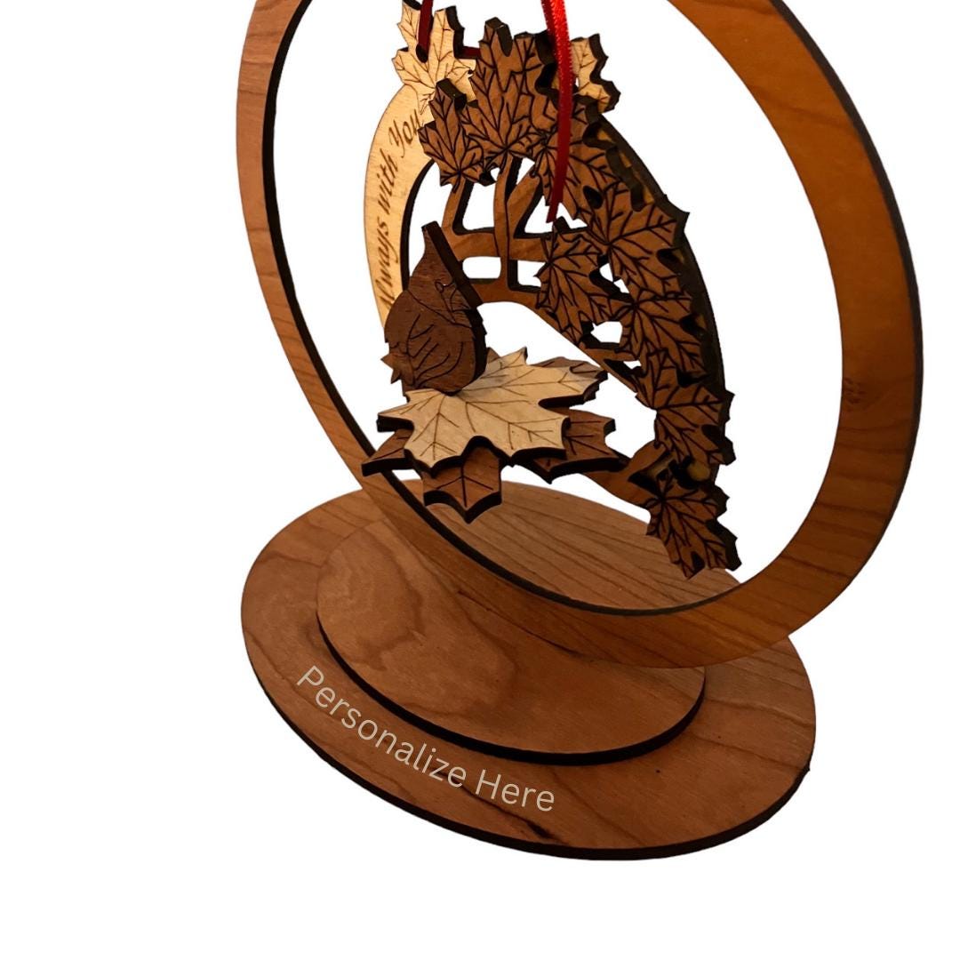 Close-up of layered wood design featuring a cardinal and leaves showing where it can be personalized