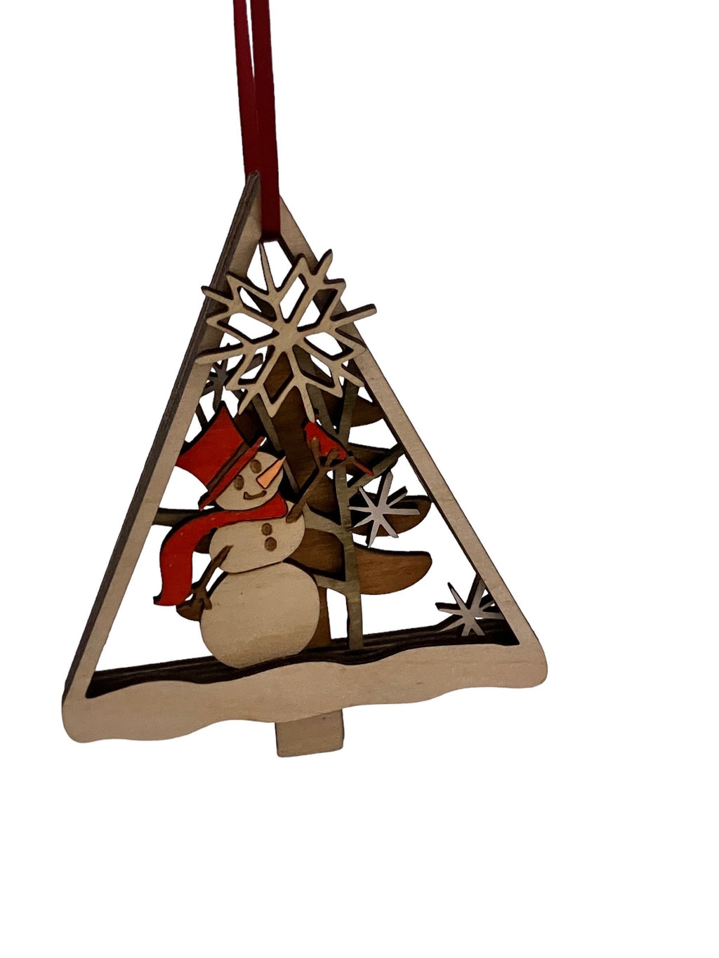 Wooden winter snowman ornament hanging in snowy background