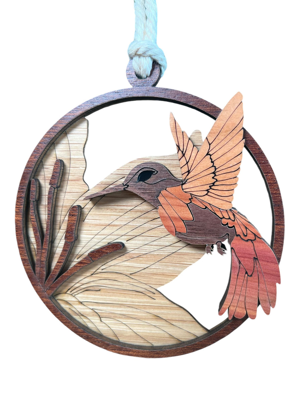 Layered wooden bird ornament featuring engraved wings and petals