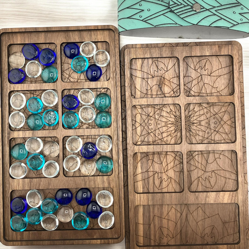 Classic handcrafted Mancala game with engraved design and glass marbles