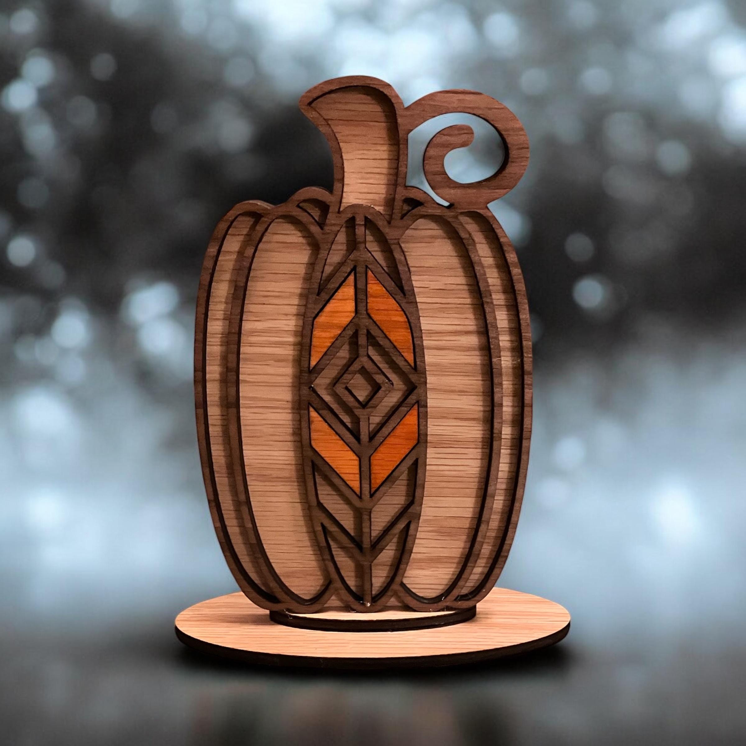 Laser cut layered wood pumpkin with geometric fall design on stand